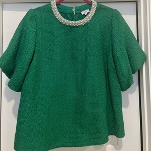 Green top with pearl neckline.